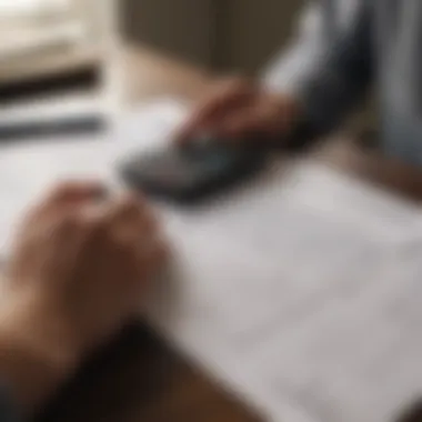 A person reviewing insurance documents with a calculator