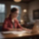 A young adult reviewing insurance plans on a laptop