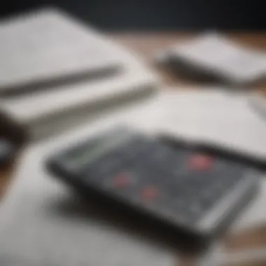 A stack of financial documents with a calculator and pen.